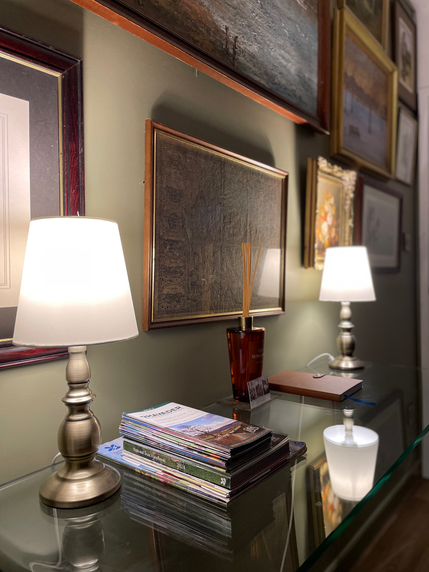 Walking leaflets and lamps on the hallway console at Ty Ray Penmaes